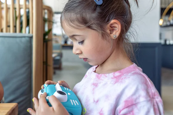 Little Girl Holds Her Hands Blue Toy Digital Camera Children — Stock Photo, Image