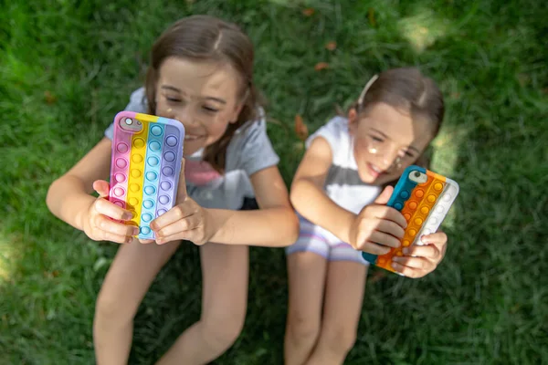 Kleine Lustige Mädchen Auf Dem Gras Mit Telefonen Einem Etui — Stockfoto