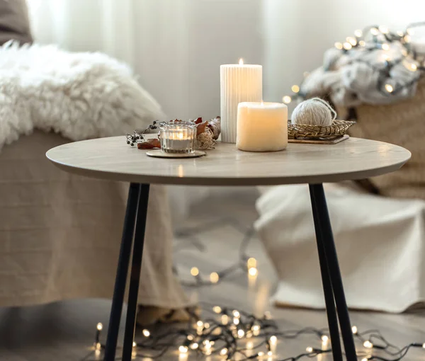Beautiful burning candles in the interior of a room in a Scandinavian style.