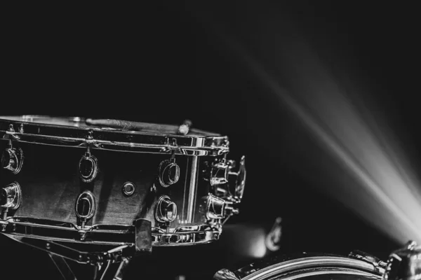 Close-up of a snare drum, percussion instrument on a dark background with beautiful lighting, copy space.