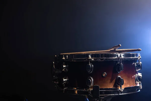 Close-up of a snare drum, percussion instrument on a dark background with beautiful lighting, copy space.