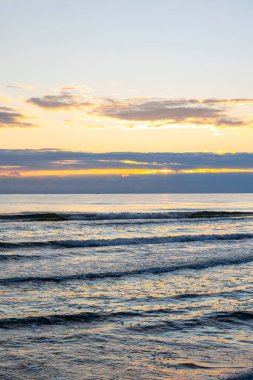 Vertical frame captures morning waves sparkling under sunlit sky. A seascape of peace, harmony and fresh inspiration.