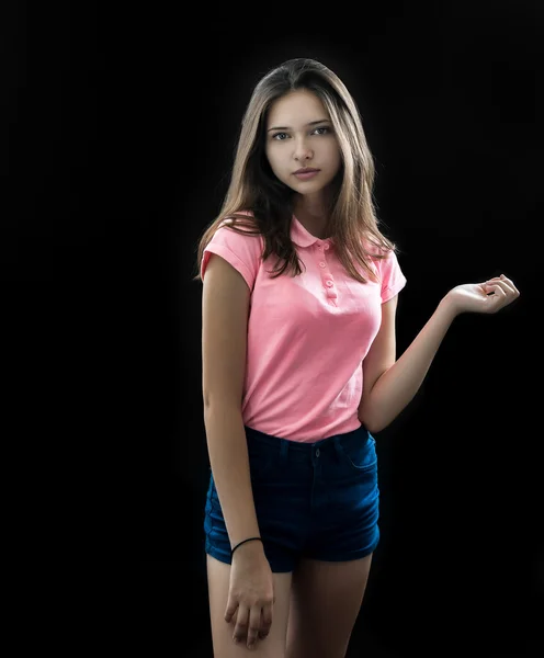 Portrait of a beautiful young brunette in the studio on a black background — Stock Photo, Image