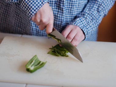 Gemide yeşil biber kesiyorum.