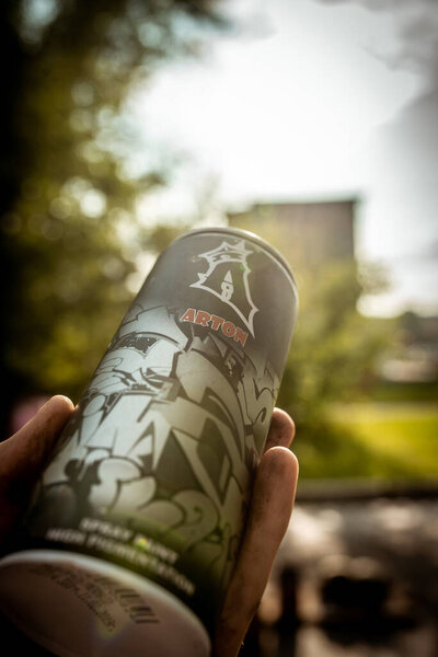 The artist holds a can of paint in his hand on "Street Art Week" festival on July 18, 2019 in Novokuznetsk, Kemerovo Region, Russian Federation.