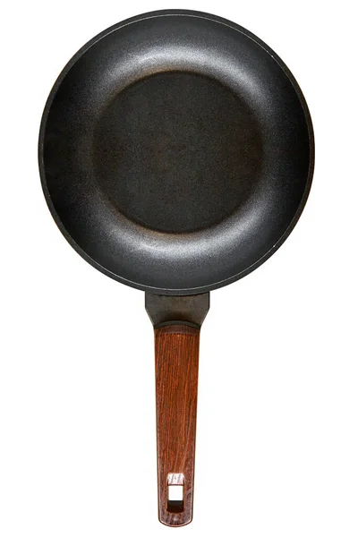 Black cast iron frying pan with wooden handle top view isolated on a white background without shadows. the concept of the kitchen, cooking, food preparation, mock up. space for text. — Stock Photo, Image