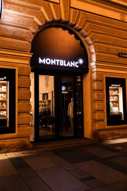 Viyana, Avusturya - 15 Aralık 2025: Montblanc mağaza tabelası gece Avusturya 'nın Viyana kentinde aydınlatıldı. Mimaride süslü detayları olan klasik Avrupa tasarımı yer almaktadır..