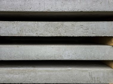 The rough surface of concrete slabs stacked on top of each other. Concrete slabs, building materials, concrete texture close-up