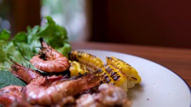 Baharatlı Padang soslu istiridye, karides, mürekkep balığı ve mısır pişirmek lezzet ve aroma dolu zengin bir deniz ürünleri tabağı yaratır. - Evet. Yüksek kalite 4k görüntü