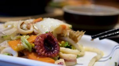 Restoranda yemek yiyen bir kadın, yakın çekim, makarna ve deniz ürünleri. Yüksek kalite 4k görüntü