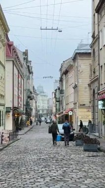 Kış sokağı, sonbahar insanları, Dünya 'daki sıradan fayanslar, Ukrayna, Lviv 01.04.2026