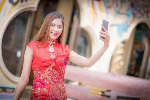 Asian Chinese woman in Traditional Chinese and hold telephone