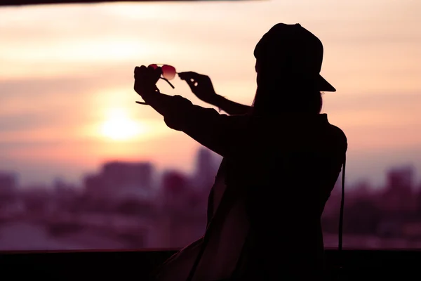 Girl shooting backlit Looking through solar glasses