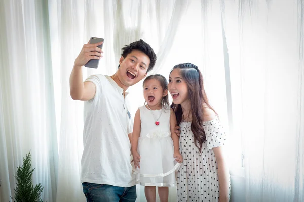 Familia con niña en el parque tomando selfie por teléfono móvil . — Foto de Stock