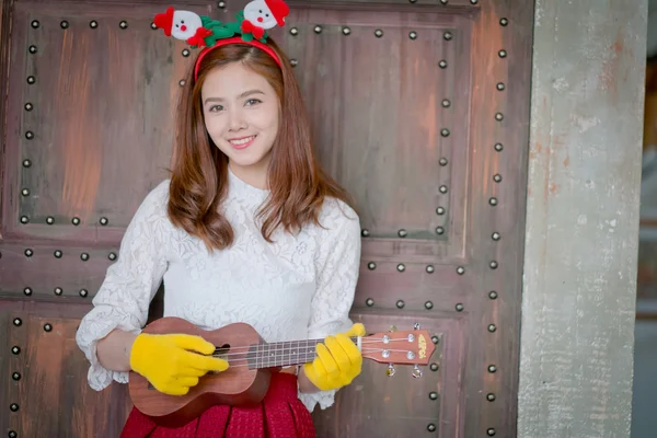 Cute girl plays ukulele in a series . — Stock Photo, Image