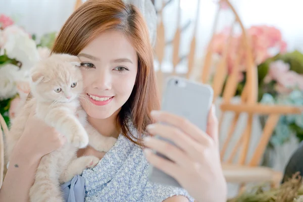 Selfie cat with a cute little girl .