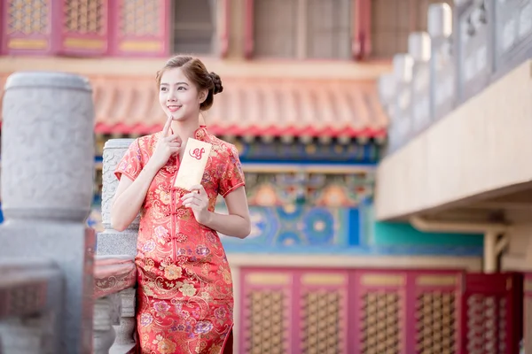 Den asiatiska kvinnan i kinesisk klänning anläggning kuplett "Lucrativ — Stockfoto