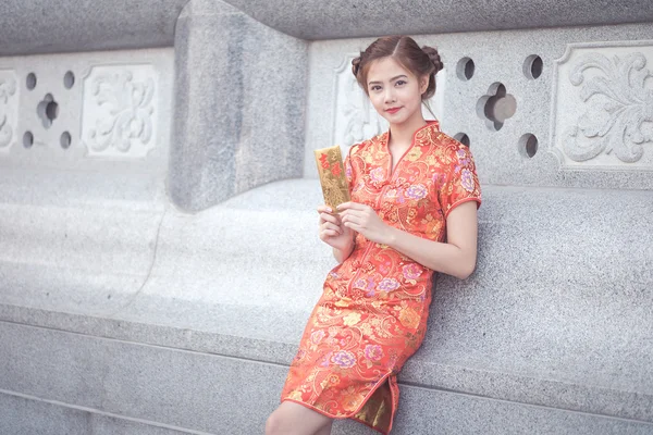 A mulher asiática em vestido chinês segurando couplet 'Happ — Fotografia de Stock