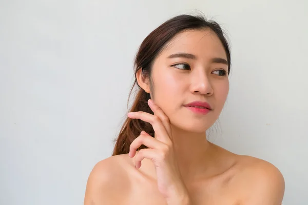 Beautiful  woman with healthy clean skin presenting something on — Stock Photo, Image