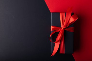 Siyah kurdeleli siyah hediye kutusu ve 11: 11 için kırmızı arkaplan, Moday, Kara Cuma, Noel veya Mutlu Yıllar arkaplanı.