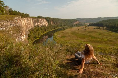  Kız dağın tepesinde oturuyor..