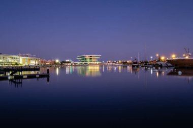 Valencia limanındaki alacakaranlık zamanı silueti yansıtılıyor.