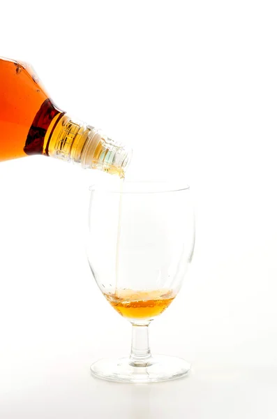 Pouring wisky on white background — Stock Photo, Image