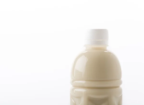 Sojamilch in Flasche auf weiß — Stockfoto