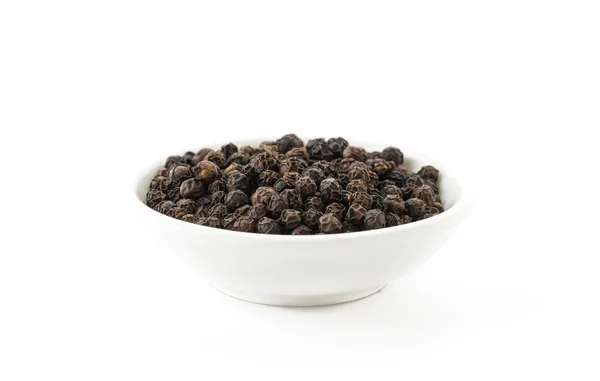 Black peppers on white background — Stock Photo, Image