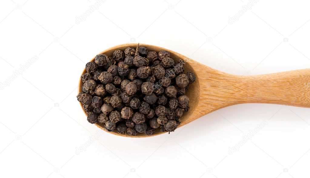 black peppers on wood spoon