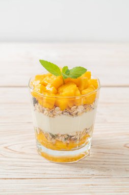 Taze mangolu yoğurt ve camlı granola. Sağlıklı yemek tarzı.