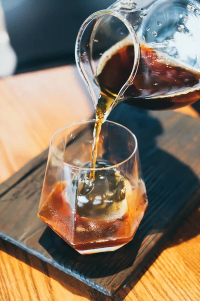 cold drip black coffee jar with glass and ice in coffee shop cafe and restaurant