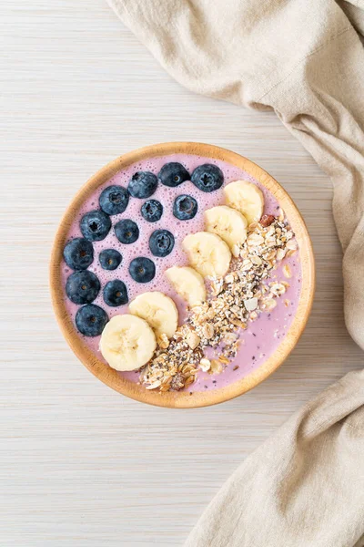 yogurt or yoghurt smoothie bowl with blue berry, banana and granola - Healthy food style