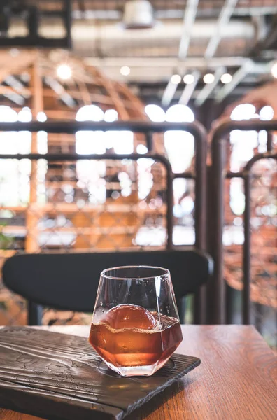 cold drip black coffee jar with glass and ice in coffee shop cafe and restaurant