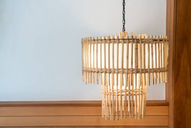 Yatak odasındaki yan yatağın üzerinde asılı duran güzel lamba süsü.