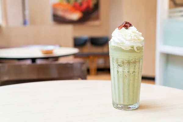 matcha green tea latte blended with whipped cream and red bean in coffee shop cafe and restaurant