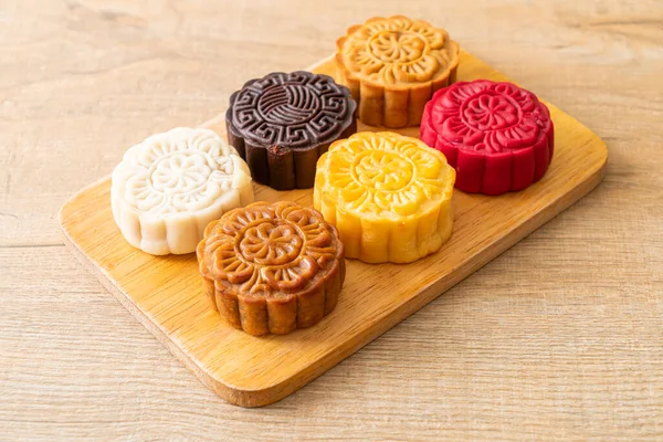 colourful Chinese moon cake with mixed flavour on wood plate