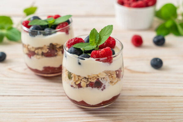 homemade raspberry and blueberry with yogurt and granola - healthy food style