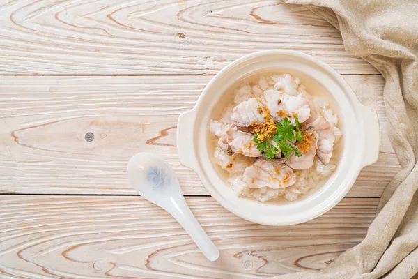 stock image porridge or boiled rice soup with fish bowl