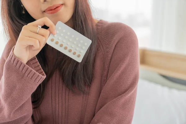 beautiful Asian women holding Birth control pill