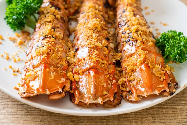 Stir Fried Mantis Shrimp with Garlic on white plate