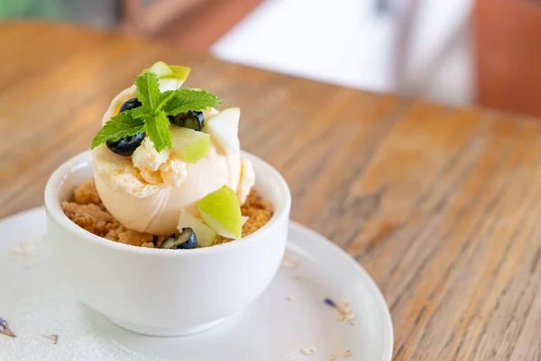 vanilla iced-cream with fresh apple and apple crumble in cafe and restaurant