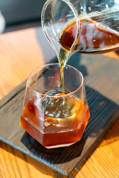 cold drip black coffee jar with glass and ice in coffee shop cafe and restaurant