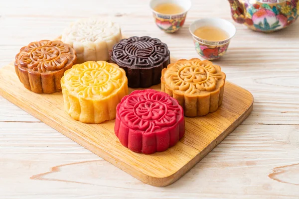 colourful Chinese moon cake with mixed flavour on wood plate