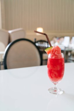 Kafe restoranındaki masada taze karpuz suyu bardağı var.