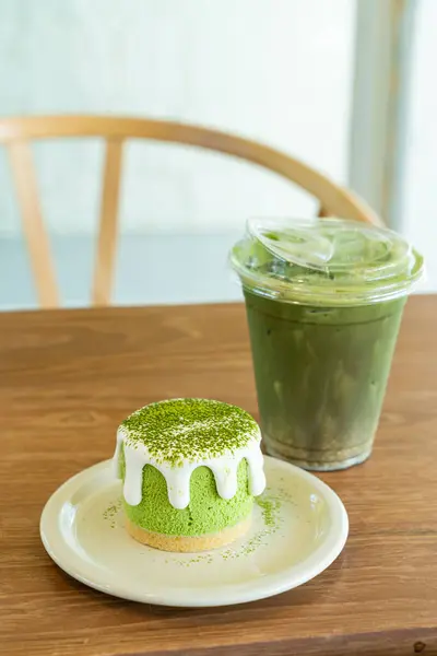 matcha green tea cheese cake with green tea cup on table in cafe restaurant