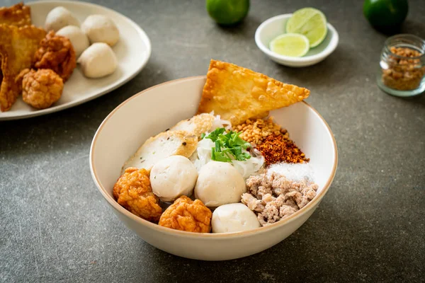 spicy small flat rice noodles with fish balls and shrimp balls without soup - Asian food style