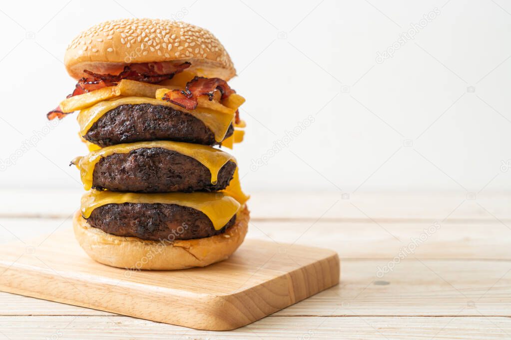 hamburger or beef burgers with cheese, bacon and french fries - unhealthy food style