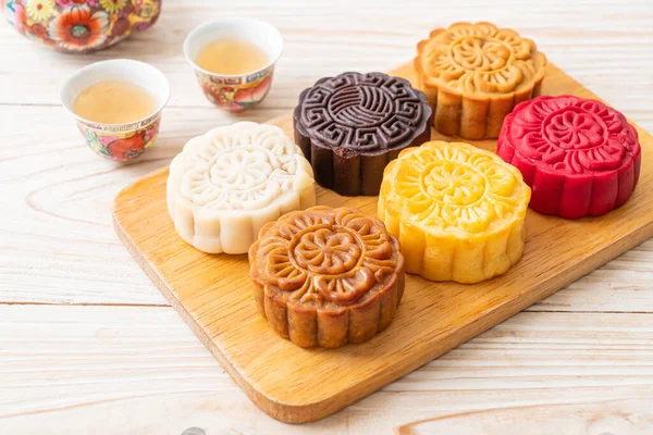 colourful Chinese moon cake with mixed flavour on wood plate