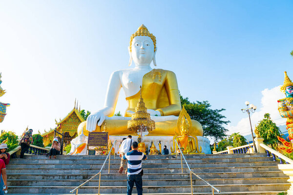 Chiang Mai, Thailand - 6 Dec 2020 : View of Wat Phra That Doi Kham (Golden Temple) at Chiang Mai, Thailand. This temple is perched on Doi Kham hill, surrounded by beautiful mountainous landscapes.